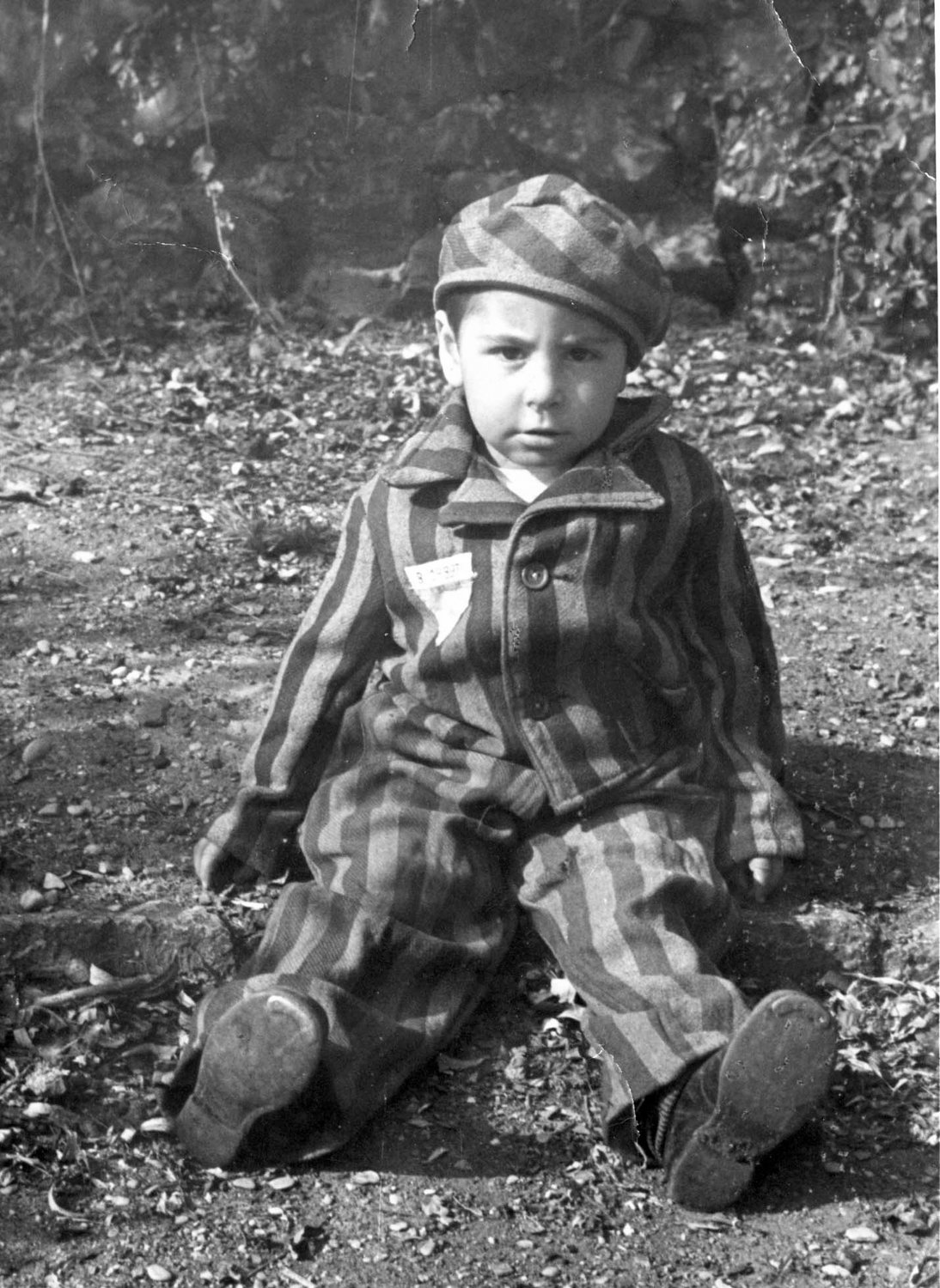 A boy wears a prisoner’s uniform after the liberation of the Nazi death camp Auschwitz-Birkenau in 1945 in Oswiecim, Poland. Historians estimate that the Nazis sent at least 1.3 million people to Auschwitz between 1940-45, and it is believed that some 1.1 million of those perished there. Auschwitz was liberated by the Russian Army Jan. 27, 1945.